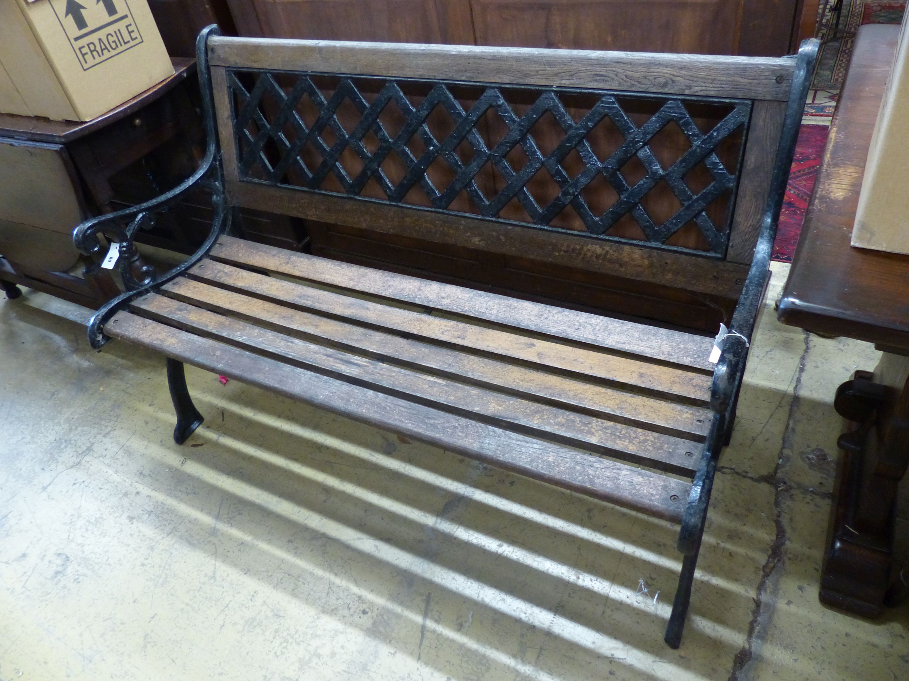 A painted cast metal slatted garden bench, length 127cm, depth 65cm, height 83cm